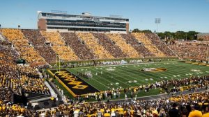 Football game at Faurot Field. Stands are packed with fans in gold.