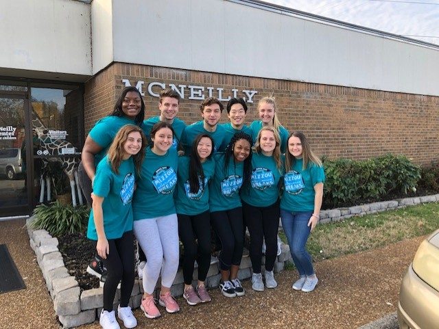 Group of students in matching "Mizzou Alternative Breaks" teal t-shirts