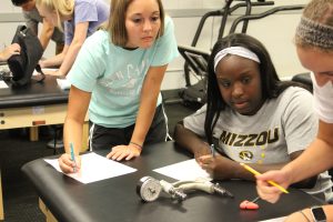 three students work together at a table