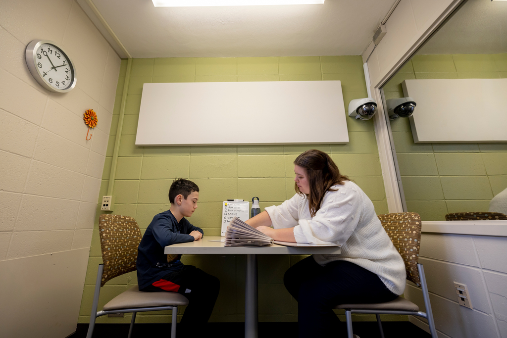 A student works with Daniel Adams in the Speech Clinic in Lewis Hall.