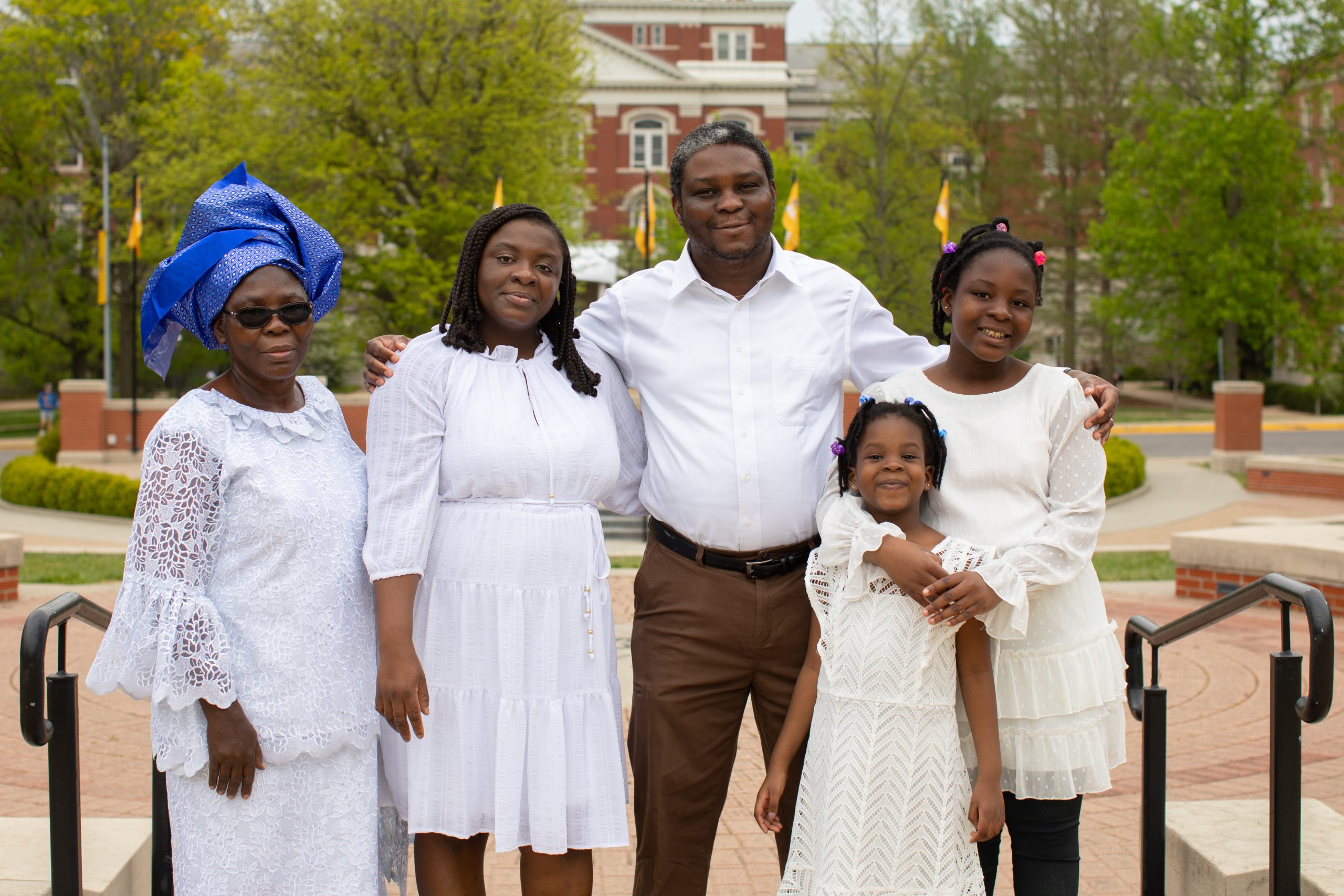 A family poses for a photo on Traditions Plaza at the University of Missouri.