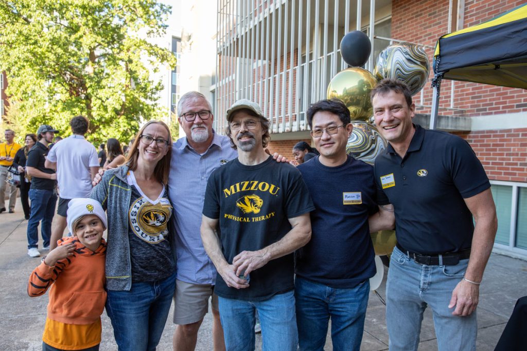 Posed picture of faculty at alumni tailgate