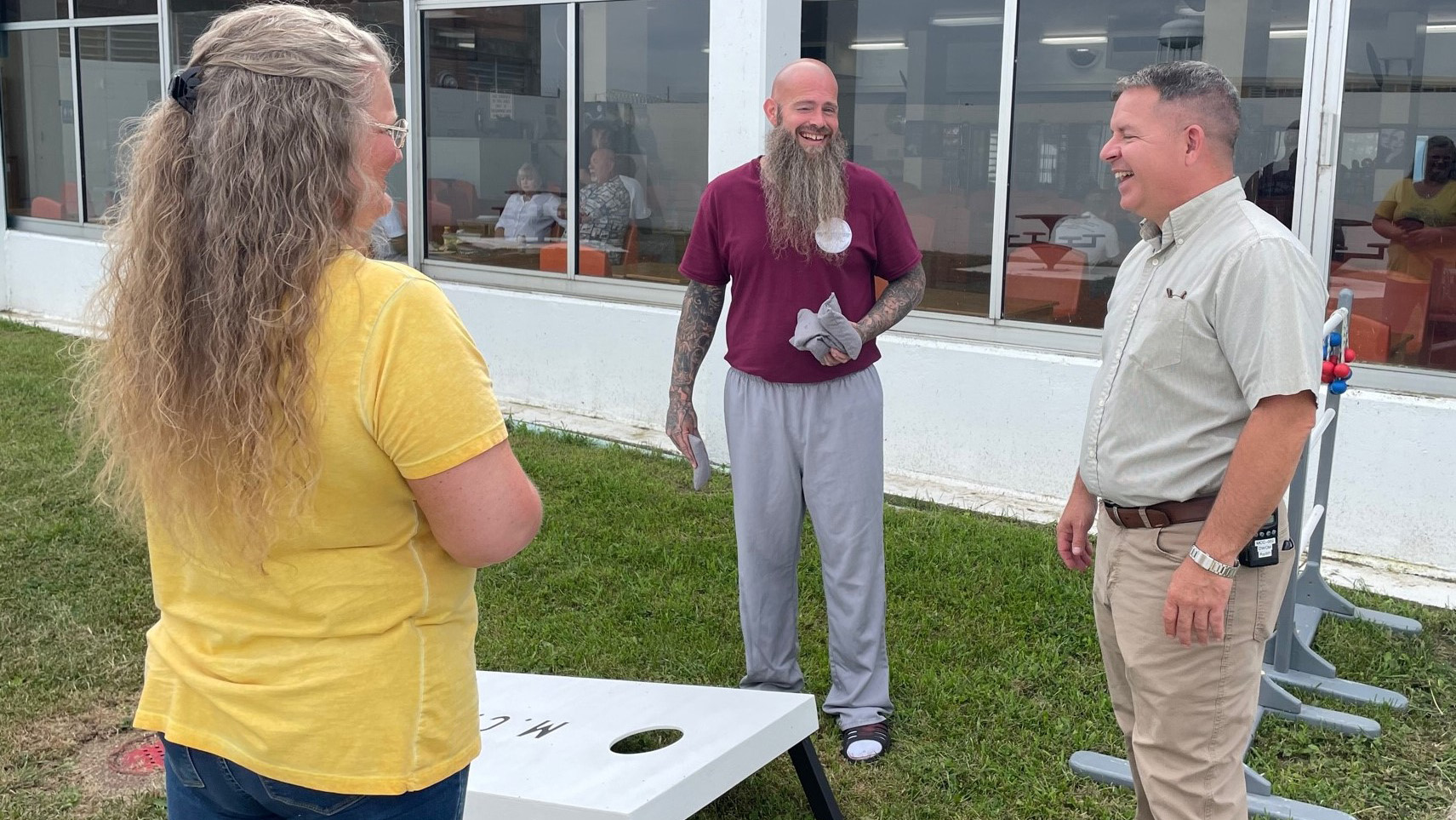 An offender at the Moberly Correctional Center plays lawn games with family members