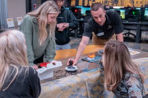 A group of people look at adaptive gaming devices