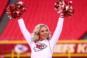 A Kansas City Chiefs cheerleader poses on the field at Arrowhead Stadium