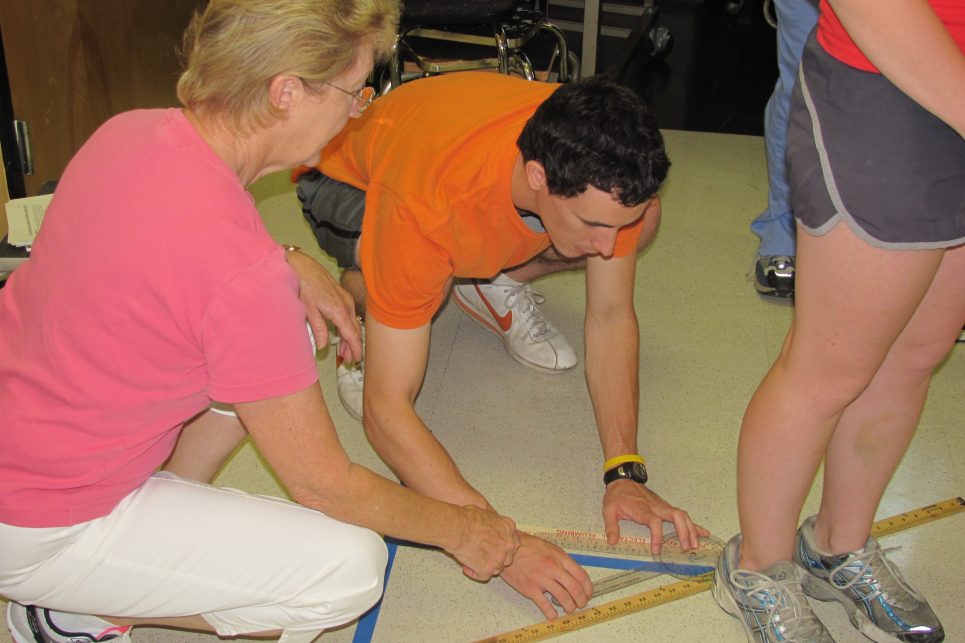 A woman and young man take measurements