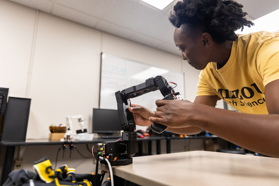A person uses a mechanical arm controller