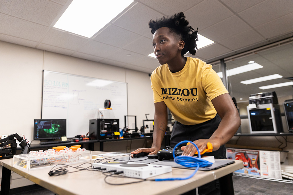 A person showcases various assistive technologies