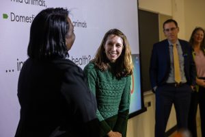 A woman smiles while receiving an award