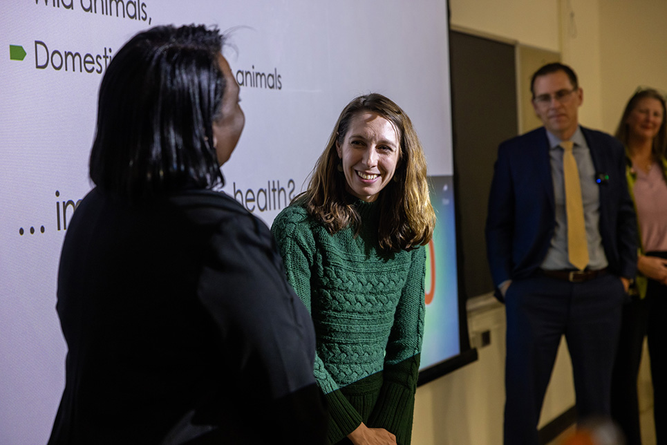 A woman smiles while receiving an award