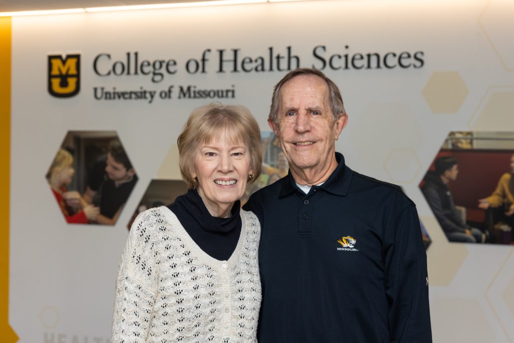 A couple stands in the lobby of the Mizzou College of Health Sciences