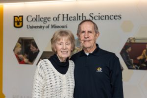 A couple stands in the lobby of the Mizzou College of Health Sciences