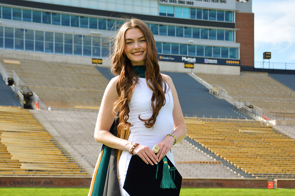 A woman walks on a football field