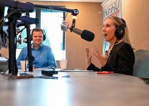 Woman speaks into a microphone