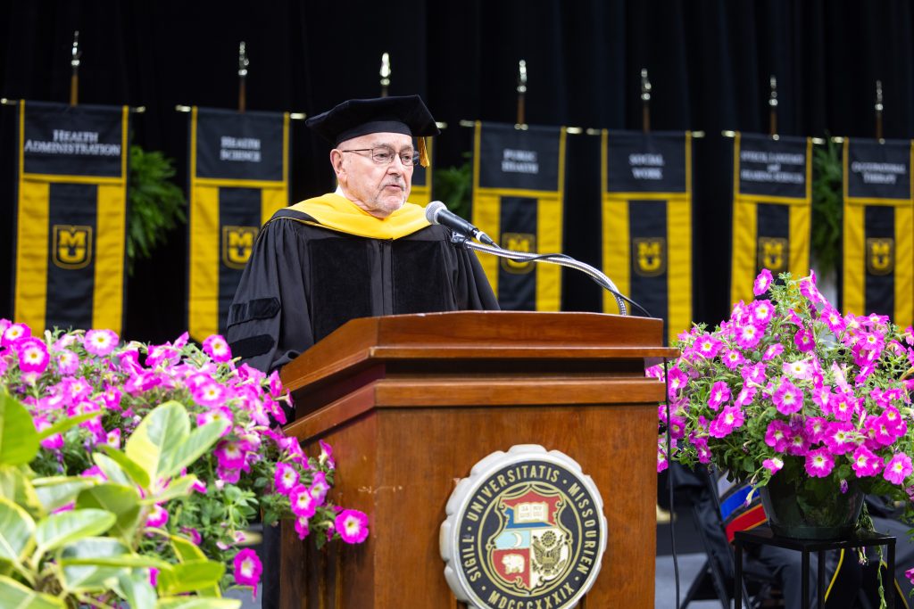 A man speaks at a commencement ceremony